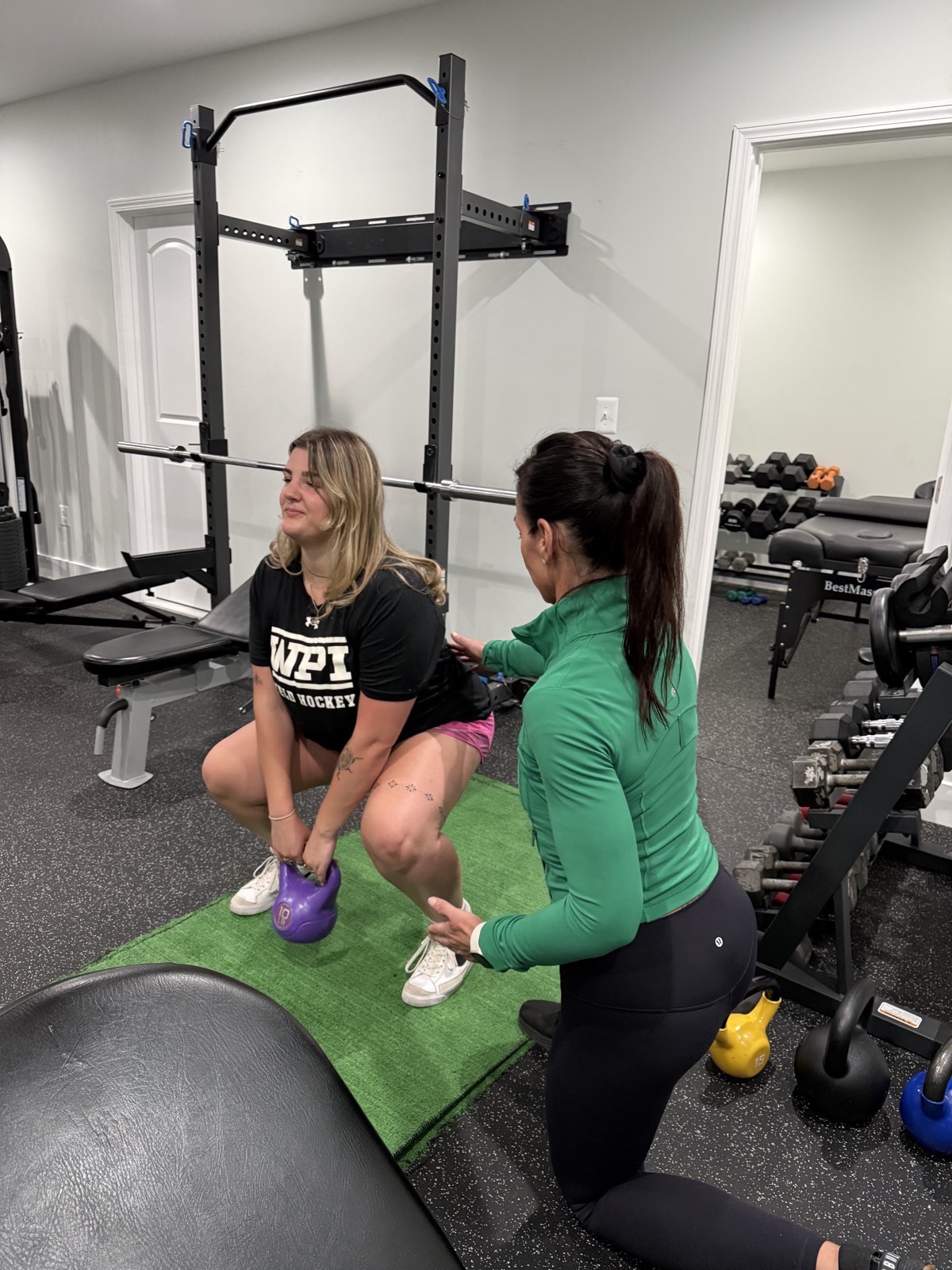 Antje coaching a kettlebell squat